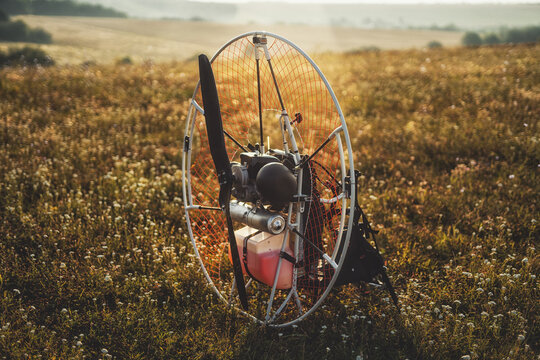 Closeup of a petrol-powered paramotor with a propeller and protection for individual paragliding flights.