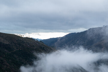 Sunrise in the mountains. Cloudy sky and low clouds. Peneda-Gerês National Park.