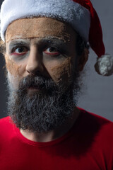 christmas portrait of scary zombie santa dead man. New year horror concept.