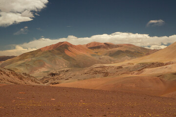 Fototapeta na wymiar Desert landscape high in the Andes mountain range. View of the brown land and colorful mountains in Laguna Brava, La Rioja, Argentina. 