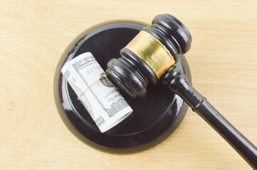 Selective focus of judge gavel and banknotes. Banking and financial law concept.