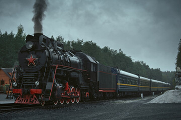 Obraz na płótnie Canvas Old retro vintage steam train on platform station Ruskeala Park