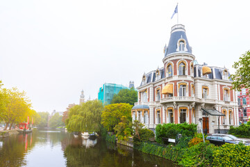 Beautiful view of Amsterdam Canals with Bridge and typical Dutch Houses.