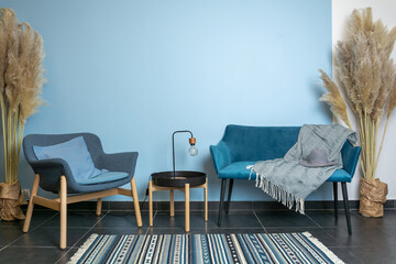 turquoise sofa and chair, classic living room decoration, blue wall, carpet on dark wooden floor,...
