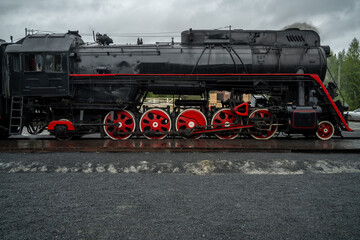 Fototapeta na wymiar Old retro vintage steam train on platform station Ruskeala Park