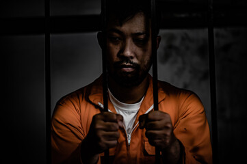 Asian man desperate at the iron prison,prisoner concept,thailand people,Hope to be free,Serious...