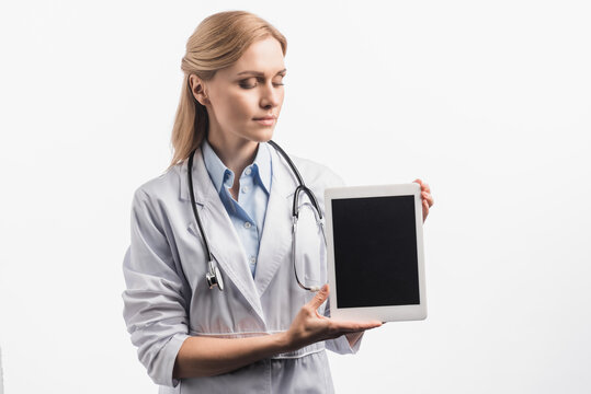 nurse in white coat holding tablet with blank screen isolated on white, stock image