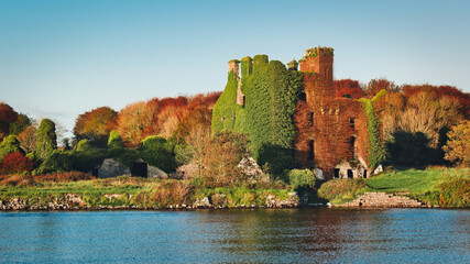 Beautiful scenery of Menlo castle surrounded by a autumn colored trees by the Corrib River at Galway, Ireland  © Hq Visual Studio