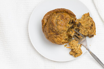 Muffin with cake fork, top view photo with selective focus and copy space