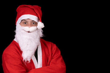 man with down syndrome dressed as santa claus on black background