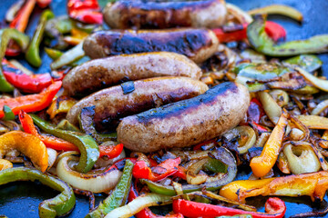 sausage and peppers on flat top grill