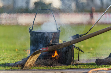 Heat shimmer and smoke over tar cooker