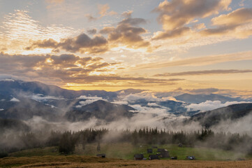 Fototapeta premium Beautiful mountain landscape. Amazing sunset in the mountains above the village.