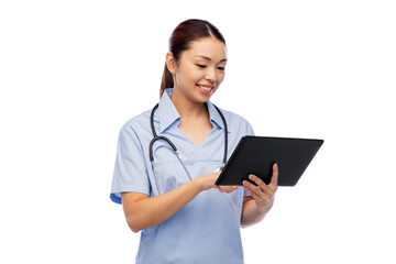 medicine, profession and healthcare concept - happy smiling asian female doctor or nurse in blue uniform with tablet pc computer and stethoscope over white background