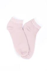 Pair of pink short socks on white background, top view