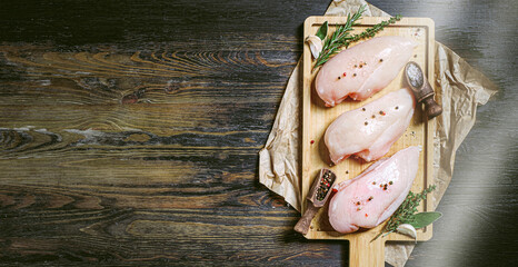 fresh raw farm chicken fillet on a cutting board.