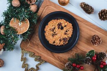Christmas healthy oatmeal cookies with dried cranberries on wooden board. Gluten free and sugar free bakery.
