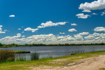  Landscape of Lobos lake on a warm spring morning, under a blue sky with a few white clouds       