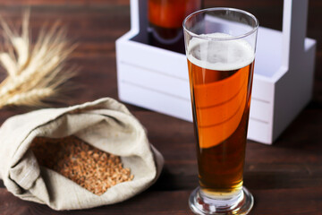 Home brewing concept. Make a lager beer with natural ingredients. Still life with beer and barley on wooden background