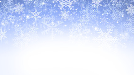 Winter blue and white gradient bokeh background with snowflakes and sparkles