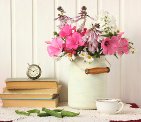 rustic composition with flowers and books.