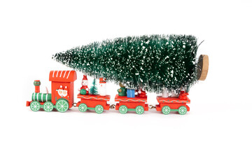 Red train toy carry on the Christmas tree on white background for creative graphic design such as new year card, note book cover, digital card 