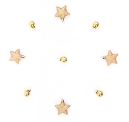 Top view of minimal golden and yellow Christmas elements, gold ball, stars glitter on white background.