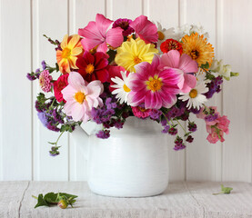 garden flowers in a teapot, bright summer bouquet. © Masquerade