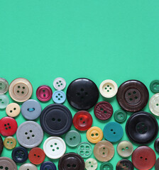 round multicolored buttons on a green background.