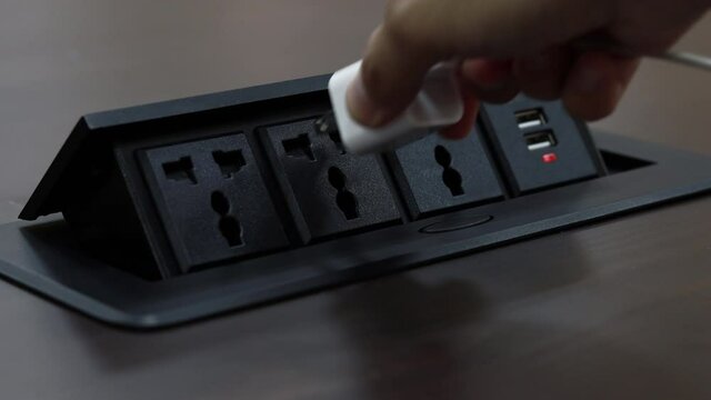 Close up young man's hand pressing button, Man's hand held the plug into the outlet And unplugging after use.