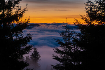 Inversion in the valley during sunrise with mountain ridge in the background, Beskydy , Czech Republic.