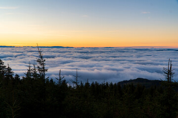 Plakat Inversion in the valley during sunrise with mountain ridge in the background, Beskydy , Czech Republic.
