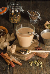 Masala tea with spices on a wooden background, a warming drink