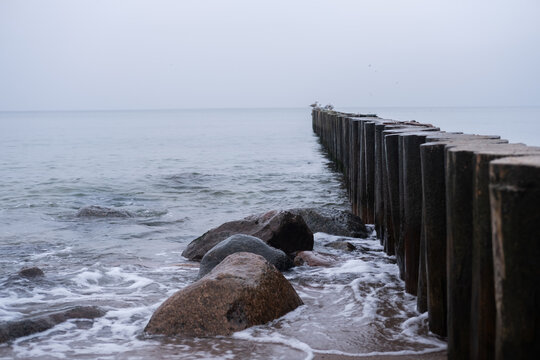 breakwaters on the shores of the Baltic Sea on an autumn cloudy day