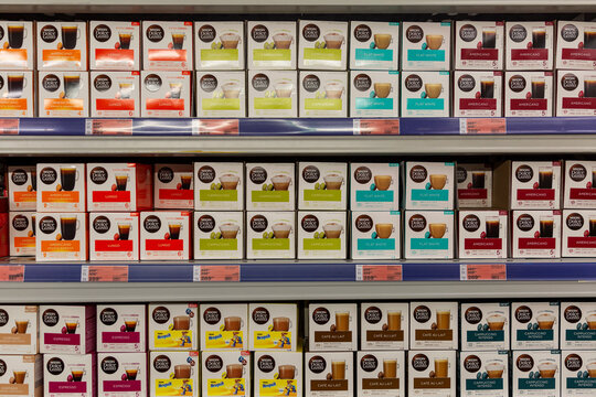 Boxes of coffee capsules on the shelves in the store. Front view. Moscow, Russia, 11/25/2020.