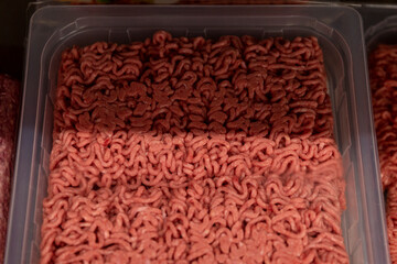 Chilled minced meat in plastic packaging in the store. Close-up.