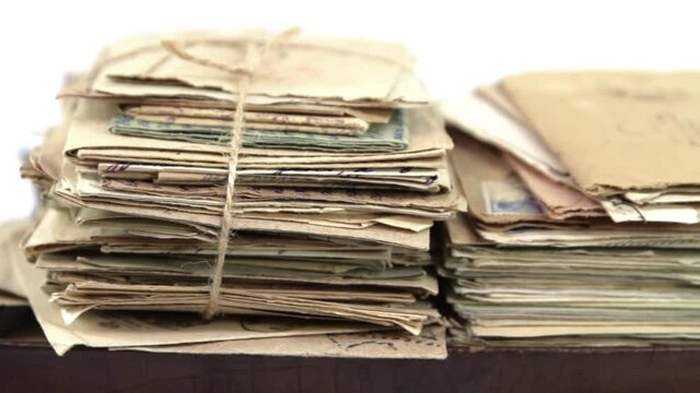 Heap of old paper postal mails in vintage suitcase