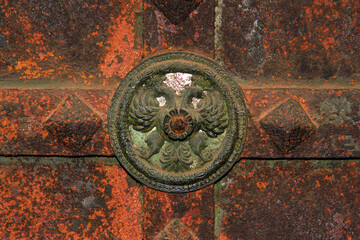 Corroded double-headed eagle door decoration element of ancient church