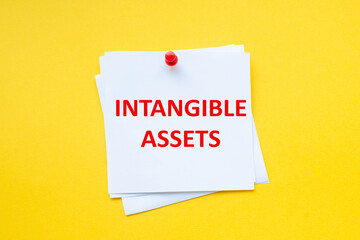 Text intangible assets on white sticker with yellow background
