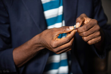 man's hand cutting nails