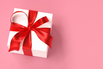 White gift box 3d with red ribbon and bow on pink background