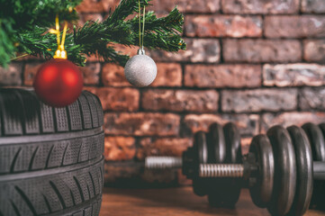 dumbbells and car tires under the tree.