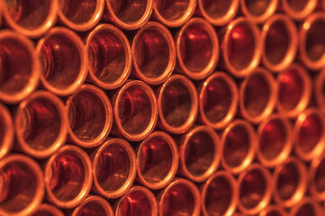 Copper pipes in neat rows close-up. Selective focus.