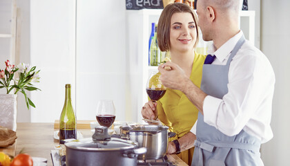 Smiling young couple cooking food in the kitchen