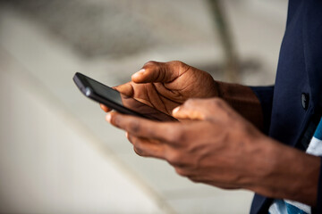 adult man's hand using a mobile phone