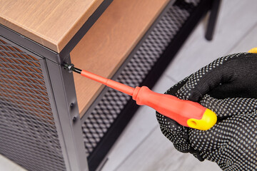 Diy assembling a piece of flat-box furniture at home.