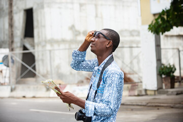 Fototapeta premium young adventurer holding a map of the city