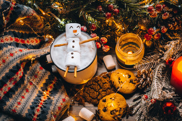 Christmas food white cup with hot chocolate snowman marshmallows. homemade cookie, cinnamon sticks...
