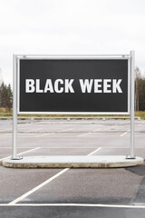 Black week sign on empty parking place - 395402756