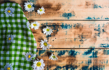 napkin and flower at old wooden plank board table background,